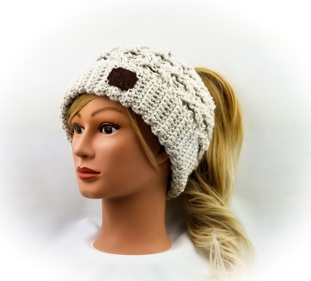 linen colored cabled messy bun hat